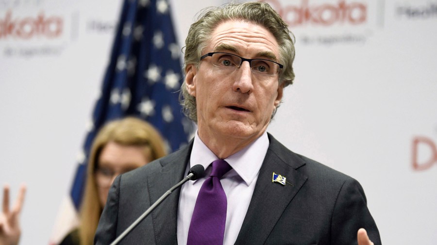 North Dakota Gov. Doug Burgum gestures as he speaks