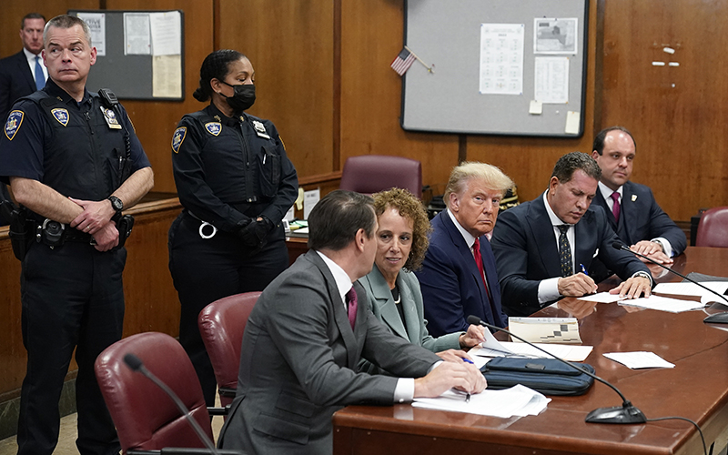 Former President Trump sits at the defense table with his legal team in a Manhattan court