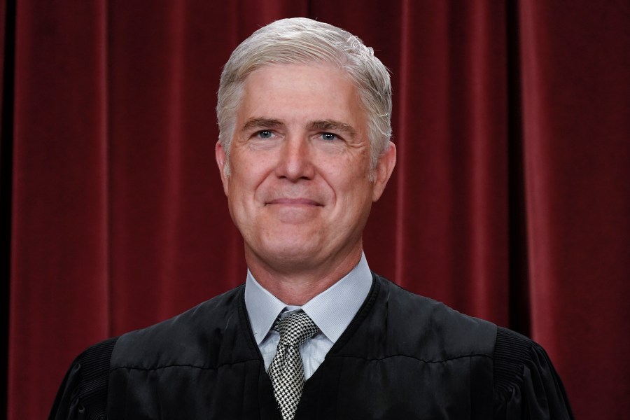 FILE - Associate Justice Neil Gorsuch joins other members of the Supreme Court as they pose for a new group portrait, at the Supreme Court building in Washington, Friday, Oct. 7, 2022. Gorsuch called emergency measures taken during the COVID-19 crisis that killed more than 1 million Americans perhaps “the greatest intrusions on civil liberties in the peacetime history of this country.” The 55-year-old conservative justice pointed to orders closing schools, restricting church services, mandating vaccines and prohibiting evictions in a broadside aimed at local, state and federal officials, even his colleagues. (AP Photo/J. Scott Applewhite, File)