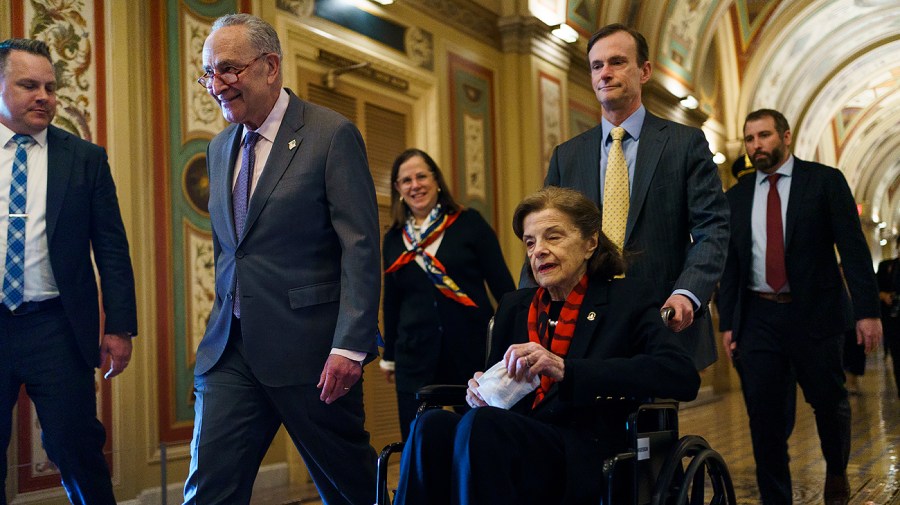 Sen. Dianne Feinstein (D-Calif.) returns to the Senate accompanied by Majority Leader Chuck Schumer (D-N.Y.)