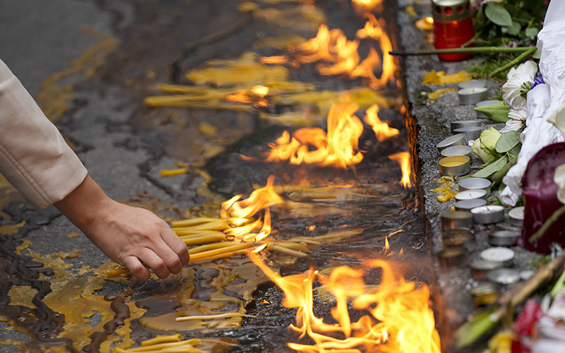 People light candles for the victims in front of the Vladimir Ribnikar school in Belgrade, Serbia