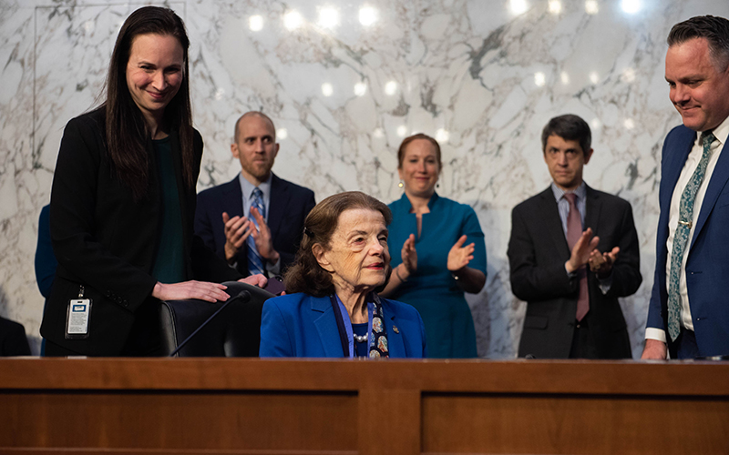 Sen. Dianne Feinstein (D-Calif.) gets a standing ovation as she arrives for a Senate Judiciary Committee business meeting