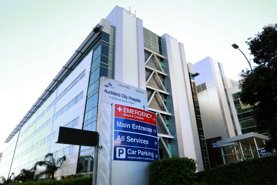 Signs are posted on the Exterior of Auckland City Hospital, May 13, 2017. New Zealand, Thursday, June 22, 2023, has been debating a thorny healthcare issue — whether ethnicity should be considered in deciding when patients get surgery. (Doug Sherring/New Zealand Herald via AP)