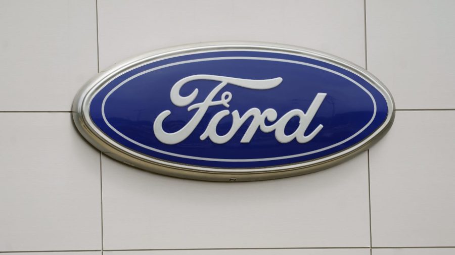 FILE - The Ford logo is seen on signage at a Ford dealership, Tuesday, July 27, 2021. The National Highway Traffic Safety Administration is investigating a Ford Motor Co. recall of more than a quarter-million Explorer SUVs in the U.S. after receiving complaints about repairs intended to prevent the vehicles from unexpectedly rolling away even while placed in “park” gear. (AP Photo/Gerry Broome, File)