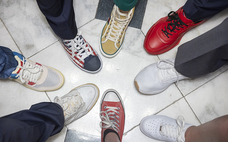 A circle of sneakers is seen from above as members of Congress celebrate Congressional Sneak Day