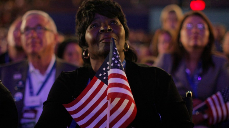 Superdelegate Margie Woods, of Will County, Ill., listens to Michelle Obama, wife of Democratic presidential candidate, Sen. Barack Obama, D-Ill., speak during the Democratic National Convention in Denver, Monday, Aug. 25, 2008. (AP Photo/Jae C. Hong)