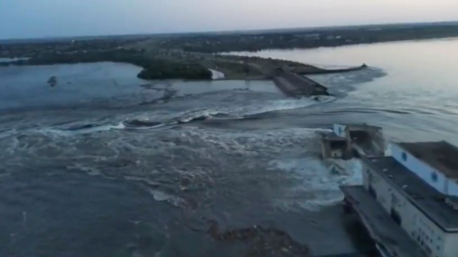 In this image taken from video released by the Ukrainian Presidential Office, water runs through a breakthrough in the Kakhovka dam in Kakhovka, Ukraine, Tuesday, June 6, 2023.