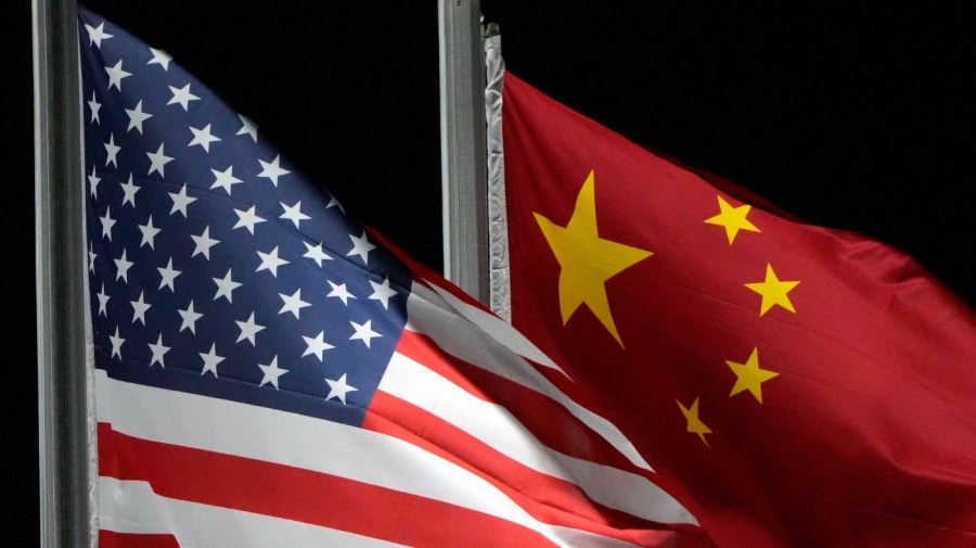 The American and Chinese flags wave at Genting Snow Park ahead of the 2022 Winter Olympics, Feb. 2, 2022, in Zhangjiakou, China. China has been operating a spy base in Cuba since at least 2019, as part of a global effort by Beijing to upgrade its intelligence capabilities. That's according to a Biden administration official who was not authorized to comment publicly and spoke on the condition of anonymity. (AP Photo/Kiichiro Sato, File)