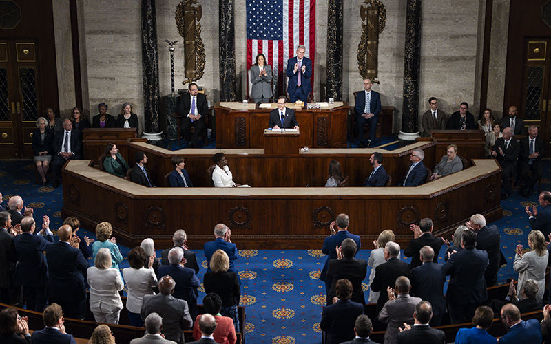 Israeli President Isaac Herzog addresses a joint meeting of Congress, shown from a distance, and encompassing the podium and audience around him.