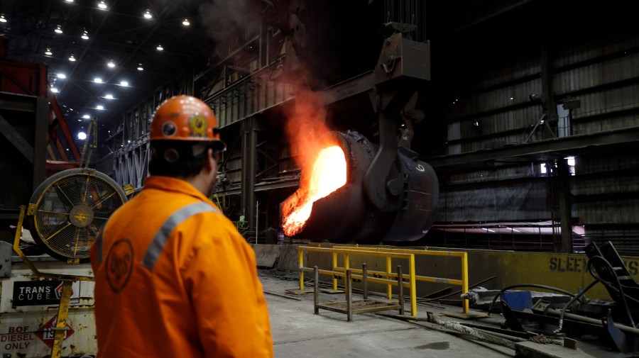 In this June 28, 2018 photo file, senior melt operator Randy Feltmeyer watches a giant ladle as it backs away after pouring its contents of red-hot iron into a vessel in the basic oxygen furnace as part of the process of producing steel at the U.S. Steel Granite City Works facility in Granite City, Ill.