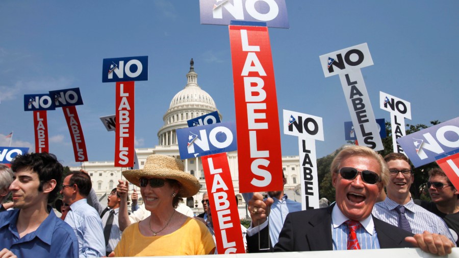 Demonstrators with the group "No Labels" carry signs as they take part in a rally on Capitol Hill.