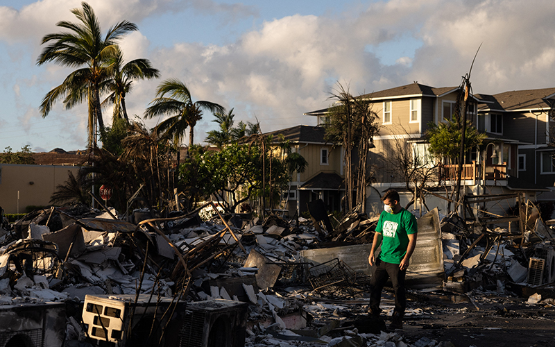 A Mercy Worldwide volunteer makes damage assessment of charred apartment complex in the aftermath of a wildfire in Lahaina