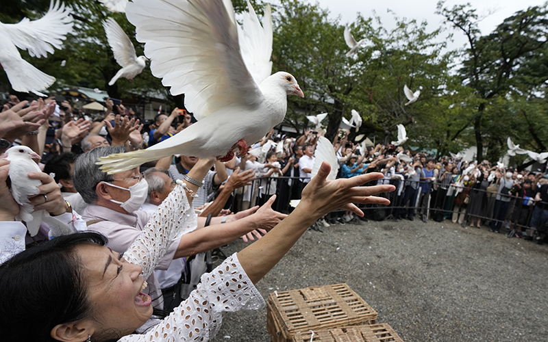 Doves are released in prayer of peace by worshippers at the Yasukuni Shrine in Tokyo, Japan