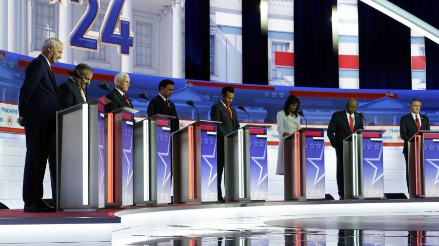 FILE - Republican presidential candidates, from left, former Arkansas Gov. Asa Hutchinson, former New Jersey Gov. Chris Christie, former Vice President Mike Pence, Florida Gov. Ron DeSantis, businessman Vivek Ramaswamy, former U.N. Ambassador Nikki Haley, Sen. Tim Scott, R-S.C., and North Dakota Gov. Doug Burgum stand on stage and listen to a prayer before a Republican presidential primary debate hosted by FOX News Channel, Wednesday, Aug. 23, 2023, in Milwaukee. (AP Photo/Morry Gash, File)