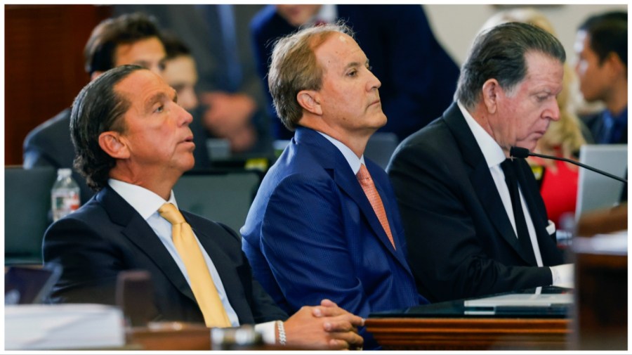 Texas state Attorney General Ken Paxton, center, sits with his attorneys Dan Cogdell, right, and Tony Buzbee, left, during his impeachment trial in the Senate Chamber at the Texas Capitol, Tuesday, Sept. 5, 2023, in Austin, Texas. (Juan Figueroa/The Dallas Morning News via AP, Pool)