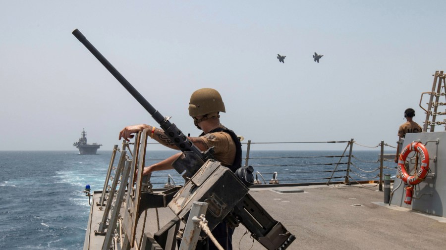 In this photo released by the U.S. Navy, two U.S. Air Force F-35A Lightning II fighter jets fly alongside amphibious assault ship USS Bataan and guided-missile destroyer USS Thomas Hudner in the Gulf of Oman, Thursday, Aug. 17, 2023.