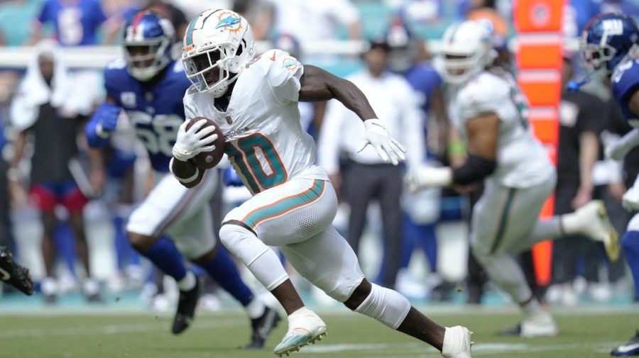 Miami Dolphins wide receiver Tyreek Hill (10) runs a play during the first half of an NFL football game against the New York Giants, Sunday, Oct. 8, 2023, in Miami Gardens, Fla. (AP Photo/Rebecca Blackwell)