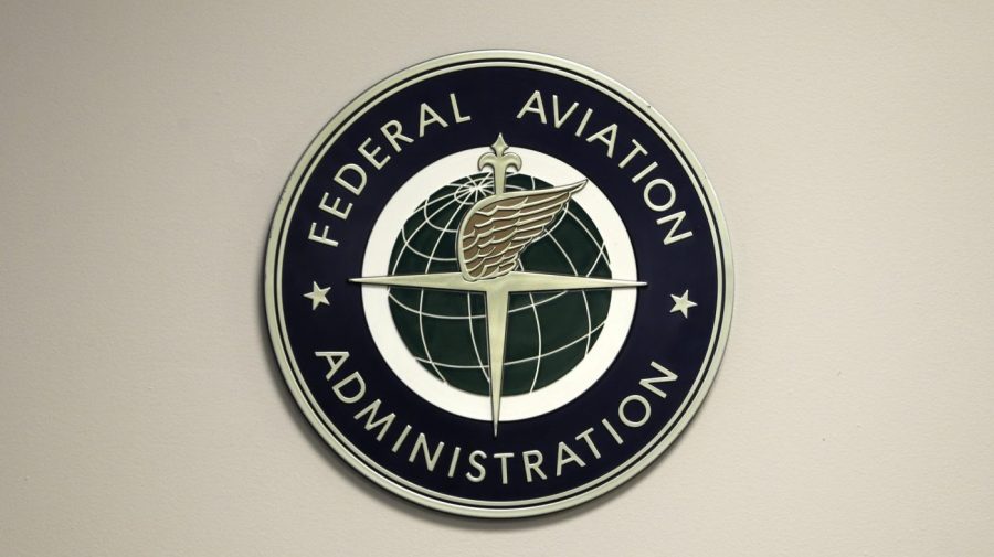 A Federal Aviation Administration sign is seen on a wall.