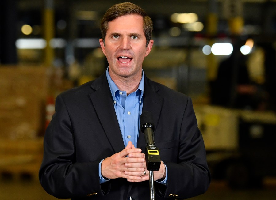 FILE - In this April. 27, 2021, file photo, Kentucky Gov. Andy Beshear speaks with reporters in Louisville, Ky. Gov. Beshear was struck by tragedy when one of his closest friends died in a mass shooting. The Democrat supports a proposal meant to keep firearms away from people deemed as threats to themselves or others. His Republican challenger offers condolences for his rival’s loss but opposes the measure. Beshear and GOP Attorney General Daniel Cameron staked out their stands on gun policy during a recent debate in Louisville. (AP Photo/Timothy D. Easley, Pool, File)