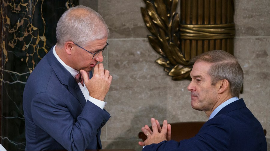 Acting Speaker Patrick McHenry (R-N.C.) talks with Rep. Jim Jordan (R-Ohio)