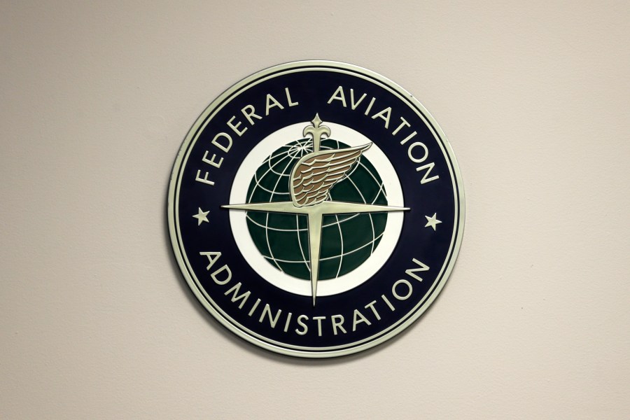 A Federal Aviation Administration sign hangs in the tower at John F. Kennedy International Airport, March 16, 2017, in New York. On Wednesday, Nov. 15, 2023, aviation experts who examined the FAA's safety record said the agency needs better staffing, equipment and technology to cope with a surge in the most serious close calls between planes. (AP Photo/Seth Wenig, File)