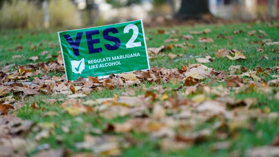 A sign supporting Issue 2 sits in a residential yard on Election Day, Tuesday, Nov. 7, 2023, in Cincinnati.