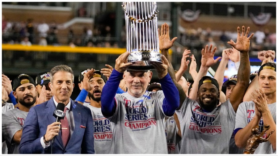 Texas Rangers manager Bruce Bochy holds up the trophy after Game 5 of the baseball World Series against the Arizona Diamondbacks Wednesday, Nov. 1, 2023, in Phoenix. The Rangers won 5-0 to win the series 4-1. (AP Photo/Brynn Anderson)