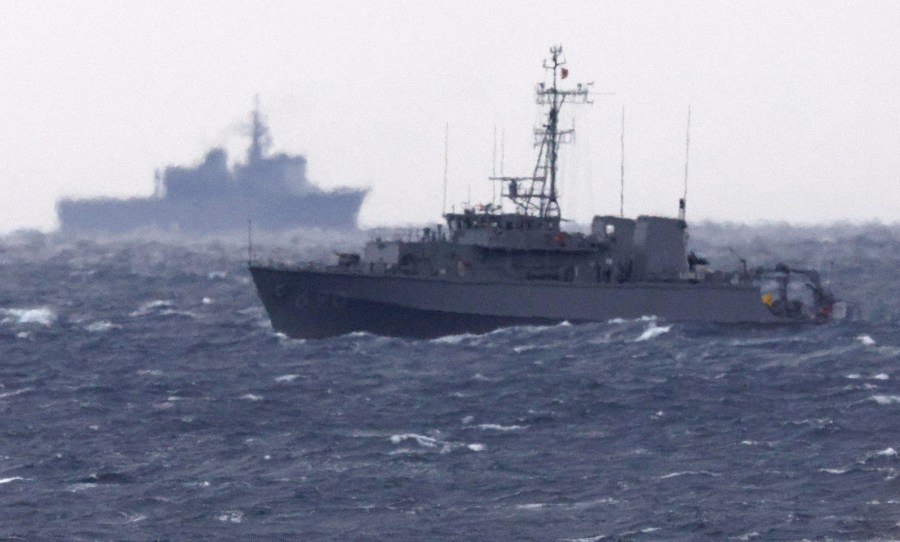 A Japanese Maritime Self Defense Force minesweeper searches in the waters where a U.S. military Osprey aircraft crashed, off Yakushima, Kagoshima prefecture, southern Japan, Friday, Dec. 1, 2023. Japan suspended flights by its Osprey aircraft Thursday, officials said, the day after the U.S. Air Force Osprey based in Japan crashed into the sea during a training mission. (Kyodo News via AP)