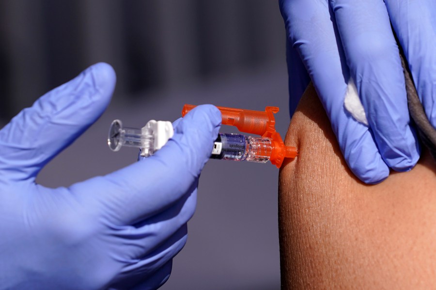 FILE - A patient is given a flu vaccine Friday, Oct. 28, 2022, in Lynwood, Calif. Seasonal flu continues to pick up steam in the U.S. But among respiratory viruses, COVID-19 remains the main cause of hospitalizations and deaths, health officials said Friday, Dec. 1, 2023. (AP Photo/Mark J. Terrill, File)