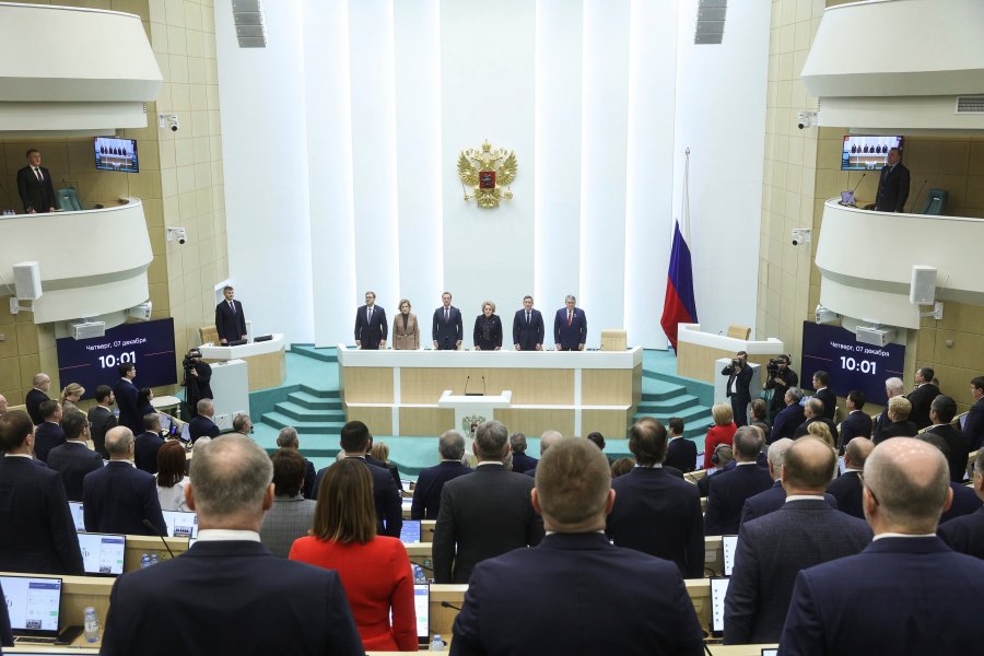 In this photo provided by The Federation Council of The Federal Assembly of The Russian Federation Press Service, lawmakers of Federation Council of the Federal Assembly of the Russian Federation listen to the national anthem prior to a session in Moscow, Russia, on Thursday, Dec. 7, 2023. Russian lawmakers have set the date of the 2024 presidential election for March 17, moving Vladimir Putin closer to a fifth term in office. (Federation Council of the Federal Assembly of the Russian Federation via AP)