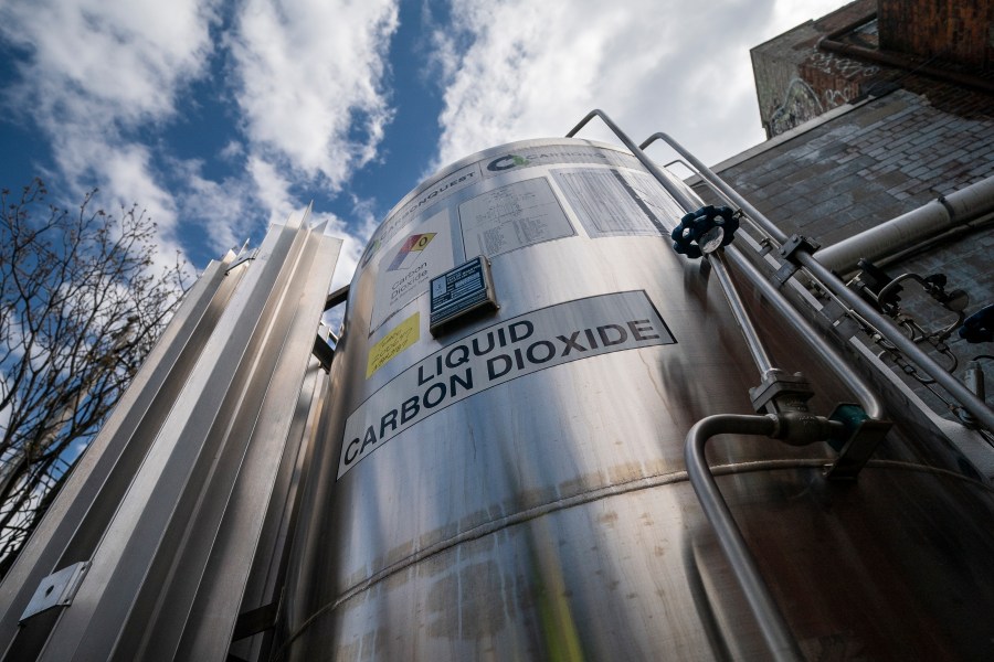FILE - A liquid carbon dioxide containment unit stands outside the fabrication building of Glenwood Mason Supply Company, April 18, 2023, in the Brooklyn borough of New York. (AP Photo/John Minchillo, File)