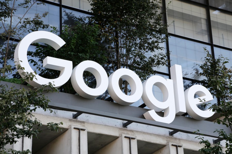 FILE - A Google sign hangs over an entrance to the company's new building, Sept. 6, 2023, in New York. Google has agreed to pay $700 million and make several other concessions to settle allegations that it had been stifling competition against its Android app store — the same issue that went to trial in another case that could result in even bigger changes. (AP Photo/Peter Morgan, File)