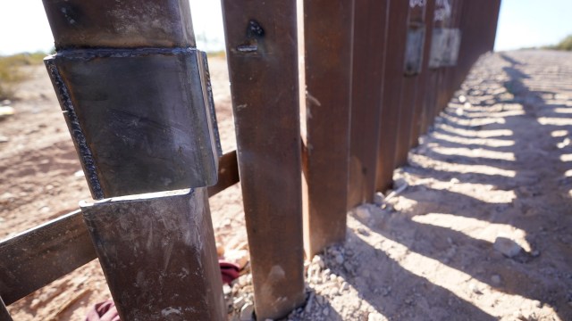 One of the steel columns of the border wall separating Arizona and Mexico is cut directly below a recent repair Friday, Dec. 15, 2023, near Lukeville, Ariz. (AP Photo/Gregory Bull)