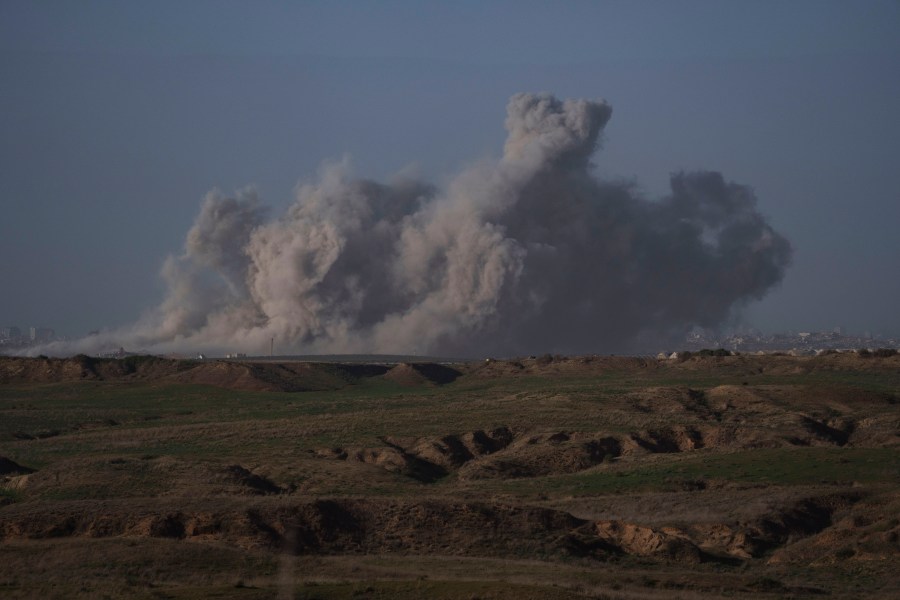 Smoke rises to the sky after an explosion in Gaza Strip as seen from Southern Israel, Friday, Dec. 22, 2023. The Israeli army is battling Palestinian militants across Gaza in the war ignited by Hamas' Oct. 7 attack into Israel. (AP Photo/Leo Correa)
