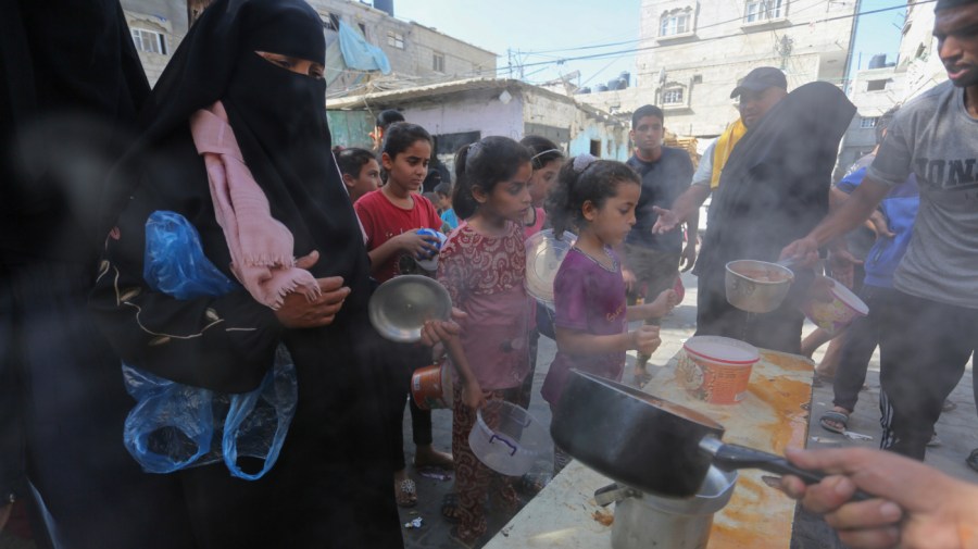 Palestinians receive food in Rafah, southern Gaza Strip, Wednesday, Nov. 8, 2023.