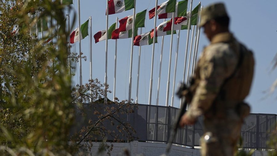 A guardsman stands watch at the U.S.-Mexico border, Wednesday, Jan. 3, 2024, in Eagle Pass, Texas. According to U.S. officials, a Mexican enforcement surge, including forcing migrants off of freight trains and flying and busing migrants to the southern part of country, has contributed to a sharp drop in illegal entries to the U.S. in recent weeks. (AP Photo/Eric Gay)