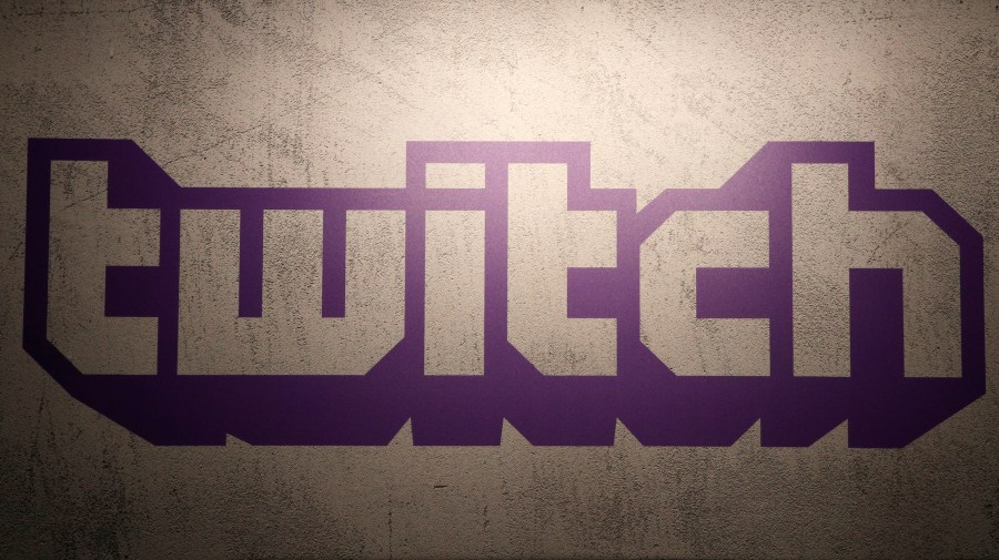 FILE - The logo for live-streaming video platform Twitch is seen on Nov. 4, 2017, at the Paris games week in Paris, France. Twitch is laying off more than 500 employees, Wednesday, Jan. 10, 2024, as the company looks to get to a more appropriate size, according to the streaming platform's CEO Dan Clancy. (AP Photo/Christophe Ena, File)