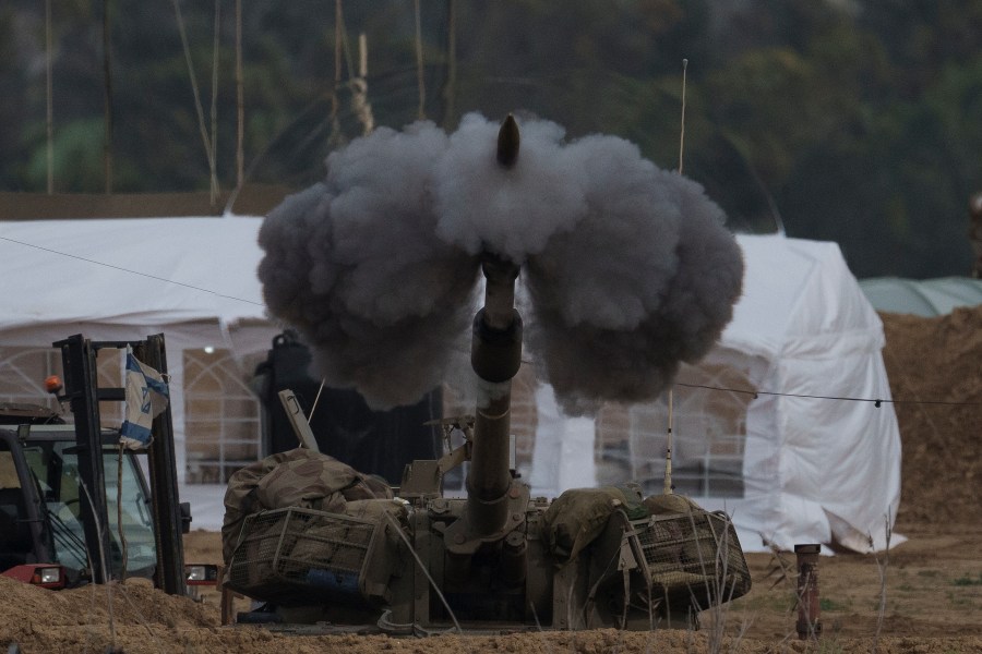 An Israeli mobile artillery unit fires a shell from southern Israel towards the Gaza Strip, in a position near the Israel-Gaza border, Sunday, Jan. 14, 2024. Sunday marks 100 days of war between Israel and Hamas after Hamas attacked Israel on Oct. 7th, killing some 1,200 people, mostly civilians, and taking 250 others hostage. In the Gaza Strip, health authorities say the death toll already has eclipsed 23,000 people. (AP Photo/Leo Correa)