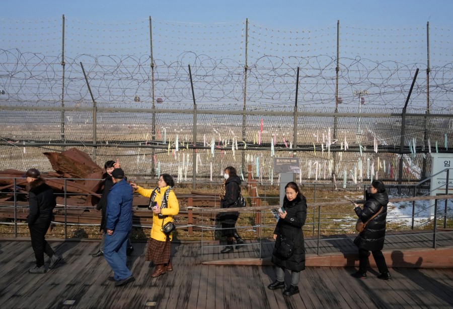 FILE - Visitors pass by a wire fence at the Imjingak Pavilion in Paju, South Korea, Wednesday, Jan. 10, 2024. North Korea has abolished key government organizations tasked with managing relations with South Korea, state media said Tuesday, Jan. 16, as authoritarian leader Kim Jong Un said he would no longer pursue reconciliation with his rival. (AP Photo/Ahn Young-joon, File)
