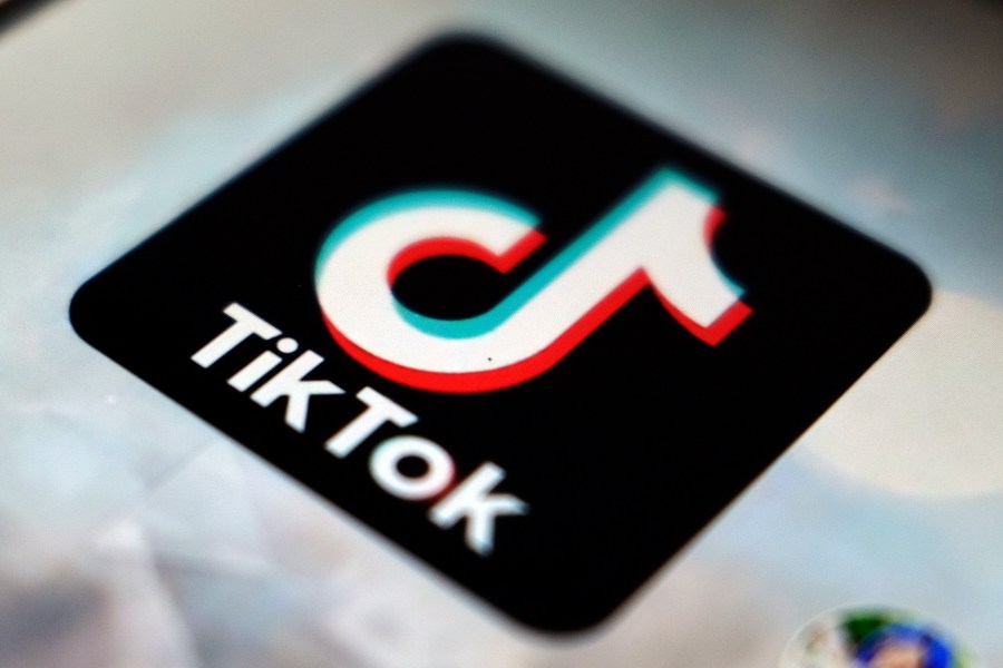 FILE - The TikTok app logo is displayed on a screen, Sept. 28, 2020, in Tokyo. A spokesperson for TikTok confirmed Tuesday, Jan. 23, 2024, that the social media platform is laying off dozens of workers in its advertising and sales unit, becoming the latest tech company to trim roles in the new year. (AP Photo/Kiichiro Sato, File)