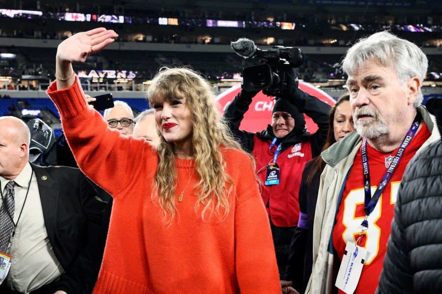 Taylor Swift waves as she walks with Ed Kelce after the AFC Championship NFL football game between the Baltimore Ravens and the Kansas City Chiefs, Sunday, Jan. 28, 2024, in Baltimore. The Chiefs won 17-10. (AP Photo/Nick Wass)