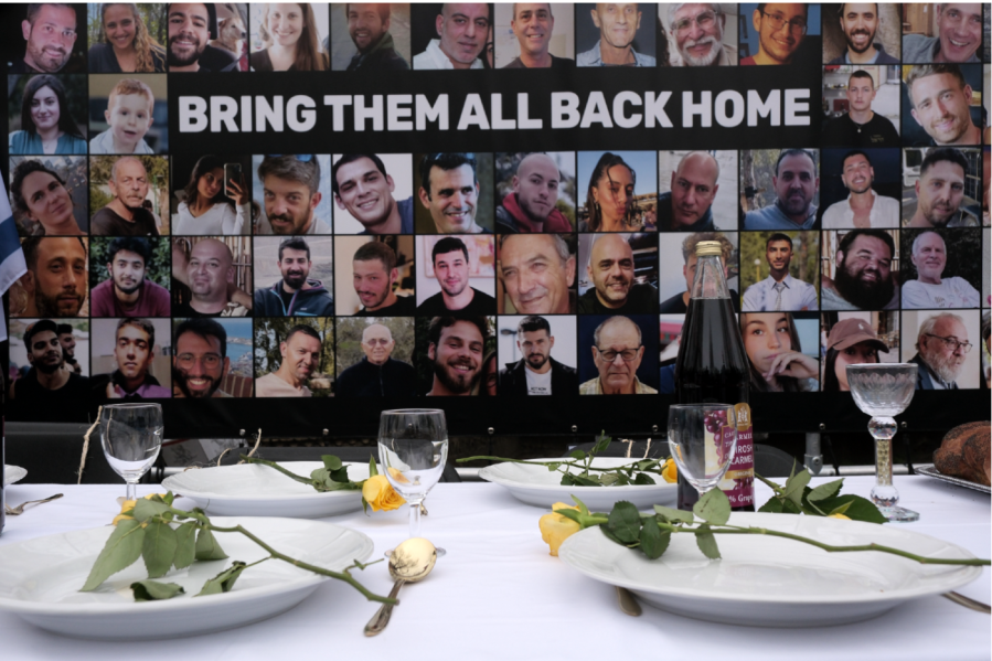 Pictures of hostages kidnapped during the Oct. 7 Hamas cross-border attack in Israel are placed by a table set during a protest outside the International Court of Justice in The Hague, Netherlands, Friday, Jan. 12, 2024.