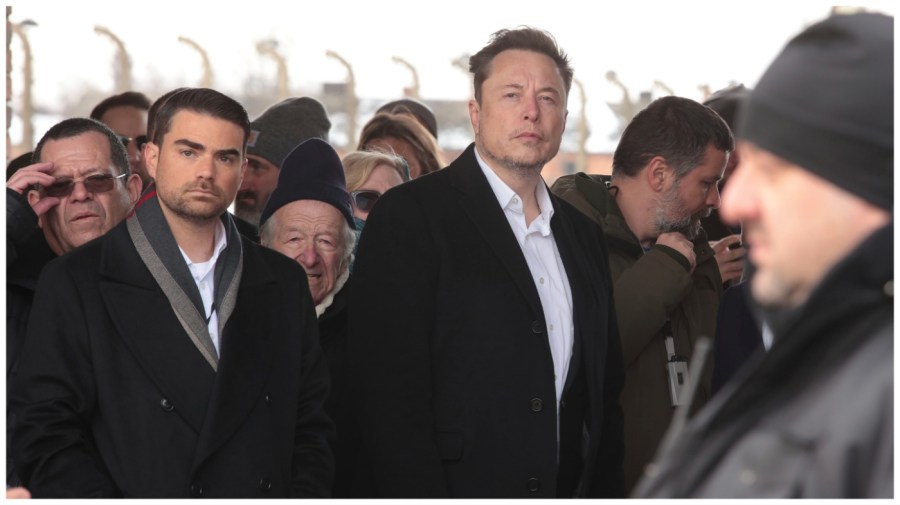 Tesla and SpaceX's CEO Elon Musk, centre, walks during his visit to the site of the Auschwitz-Birkenau Nazi German death camp in Oswiecim, Poland, on Monday, Jan. 22, 2024. The private visit was apparently in response to calls from some Jewish religious leaders for Musk to see with his own eyes the most symbolic site of the horrors of the Holocaust. (AP Photo/Andrzej Rudiak)
