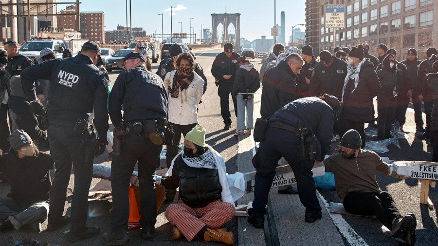 Police make arrests as protestors block Brooklyn Bridge during a pro-Palestinian demonstration demanding a cease-fire in the Israel-Palestinian conflict on Monday, Jan. 8, 2024, in New York.