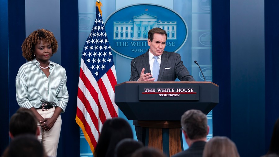 National Security Council spokesperson John Kirby speaks to reporters as White House press secretary Karine Jean-Pierre waits off to the side.