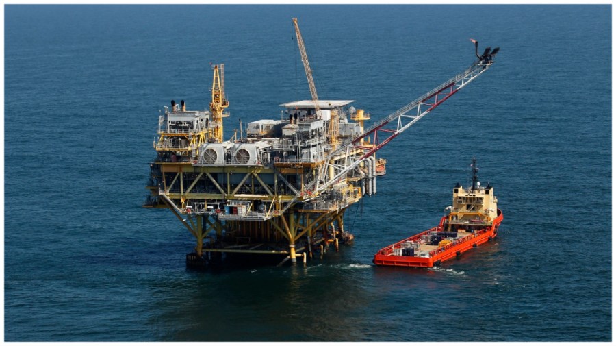 A rig and supply vessel are pictured in the Gulf of Mexico.