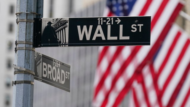 FILE - A street sign is seen in front of the New York Stock Exchange in New York, Tuesday, June 14, 2022. Wall Street headed lower early Tuesday, Dec. 5, 2023, after Moody's Investor Service downgraded China's sovereign debt rating as the country's real estate crisis seeps into its local government and private financing. (AP Photo/Seth Wenig, File)
