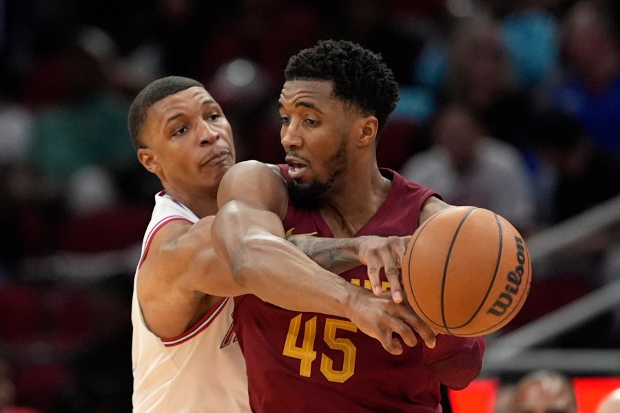 Houston Rockets' Jabari Smith Jr., left, knocks the ball away from Cleveland Cavaliers' Donovan Mitchell (45) during the second half of an NBA basketball game Saturday, March 16, 2024, in Houston. The Rockets won 117-103. (AP Photo/David J. Phillip)