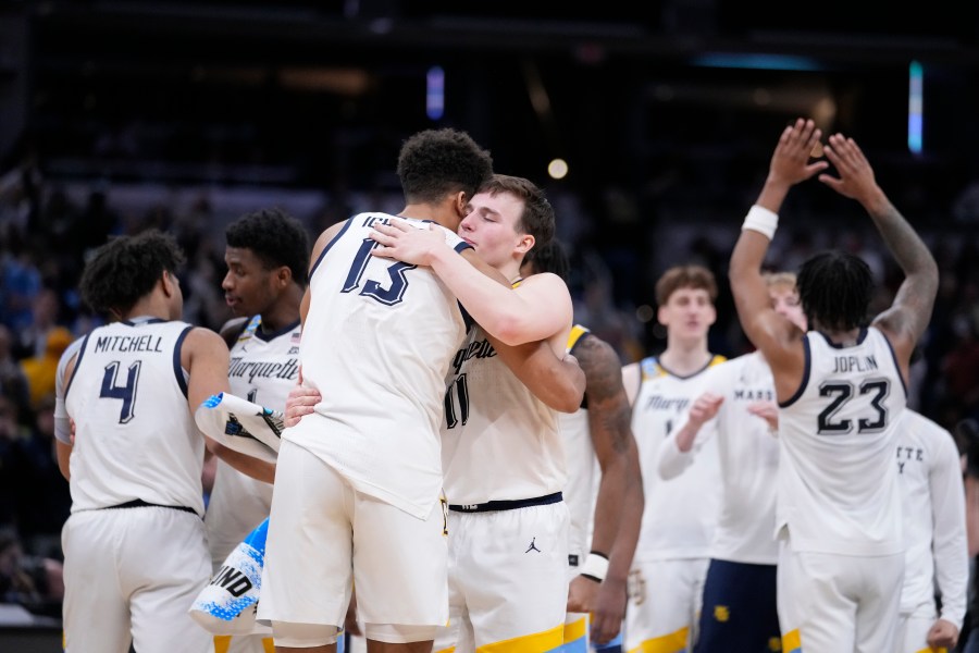 Marquette's Tyler Kolek (11) and Oso Ighodaro (13) celebrates with teammates following a second-round college basketball game against Colorado in the NCAA Tournament, Sunday, March 24, 2024 in Indianapolis. Marquette won 81-77. (AP Photo/Michael Conroy)