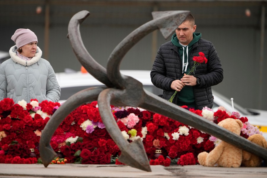 A man lays flowers at a spontaneous memorial in memory of the victims of Moscow attack in St. Petersburg, Russia, Sunday, March 24, 2024. Russia observed a national day of mourning on Sunday, two days after an attack on a suburban Moscow concert hall that killed over 130 people. (AP Photo/Dmitri Lovetsky)